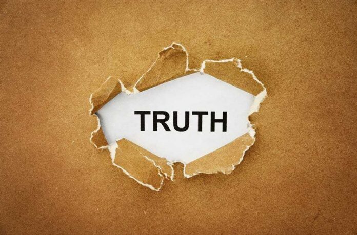 shutterstock_211611715.jpg A piece of torn paper revealing the word TRUTH underneath