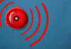 Red alarm bell on a blue background.