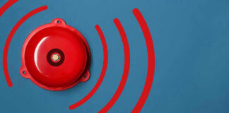 Red alarm bell on a blue background.