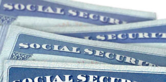 Several Social Security cards stacked together.