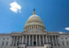 U.S. Capitol building against a clear blue sky.