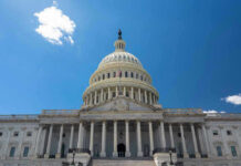 U.S. Capitol building against a clear blue sky.