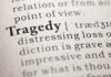 Close-up of the word 'Tragedy' in a dictionary with its definition