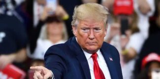 Navy Chief FIRED–SUDDENLY–WHY? A speaker at a rally pointing towards the audience