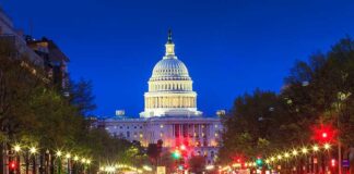 SHOOTING Aftermath–TENSE ROYALS Land in D.C. The U.S. Capitol building illuminated at night with city traffic in the foreground