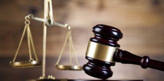 Court Bombshell THREATENS Virginia Map Vote A wooden gavel and scales of justice on a wooden surface