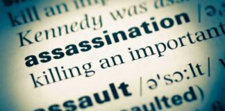 Defense Minister ASSASSINATED—Al Qaeda Strikes Capital Close-up of a dictionary page showing the definition of 'assassination'