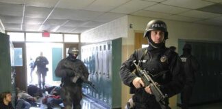 Police officers responding to a school emergency with students on the floor