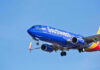 Robots BANNED! Airline’s SHOCKING Ruling Southwest Airlines plane flying in blue sky.