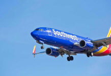 Robots BANNED! Airline’s SHOCKING Ruling Southwest Airlines plane flying in blue sky.