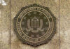 Bald Eagle Killer Faces Federal Hammer FBI seal on a marble wall.
