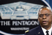 Strait of Hormuz: Oil Supply in Peril! Man speaking in front of Pentagon sign.