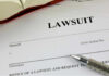 Scandal Erupts: Misleading Photo Ignites Legal Battle Lawsuit paperwork with pen and open book.