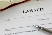Scandal Erupts: Misleading Photo Ignites Legal Battle Lawsuit paperwork with pen and open book.