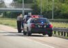 Tragic Collision SPARKS Border Accountability Debate Police officer conducting a traffic stop on a highway