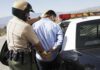 Fleeing Teens TARGETED: Dad Faces FELONY Police officer arresting a suspect near a patrol car