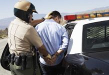 Fleeing Teens TARGETED: Dad Faces FELONY Police officer arresting a suspect near a patrol car