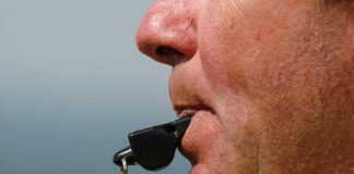 Navy Insiders EXPOSED: Millions Stolen! Close-up of a sports coach blowing a whistle