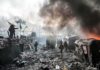 Kremlin’s SHOCKING Accusation — But Is It True? A chaotic protest scene with smoke, fire, and people holding flags