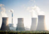 Governments Are Quietly Betting Big on Nuclear Power Four cooling towers of a power plant emitting steam.