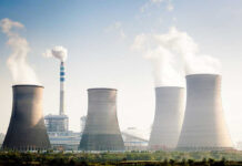 Governments Are Quietly Betting Big on Nuclear Power Four cooling towers of a power plant emitting steam.