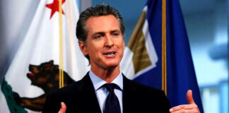 Federal Drilling Plan Sparks Santa Barbara Fight Man speaking with flags in the background