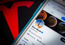 Trillionaire Shock: Musk Lights Fuse Phone screen showing Twitter profile with spacescapes.