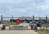 Judge Orders ICE Release of Wisconsin Mosque Leader Chain-link fence with Restricted Area Stop No Photography sign.