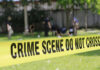 Festival Horror: Newborn Found Dead in Festival Porta-Potty Yellow crime scene tape blocking grassy area.