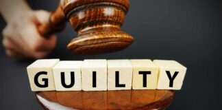 Judge Arrested in Alleged Parking-Lot Assault A gavel above wooden blocks spelling 'GUILTY'