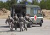 Deadly Strike Hits Military Vehicle Soldiers running towards a medical vehicle during a military operation