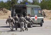 Deadly Strike Hits Military Vehicle Soldiers running towards a medical vehicle during a military operation