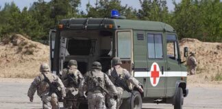 Deadly Strike Hits Military Vehicle Soldiers running towards a medical vehicle during a military operation