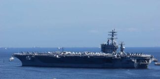 U.S. Helicopter Loss Near Hormuz Ignites Crisis A large aircraft carrier sailing in the ocean