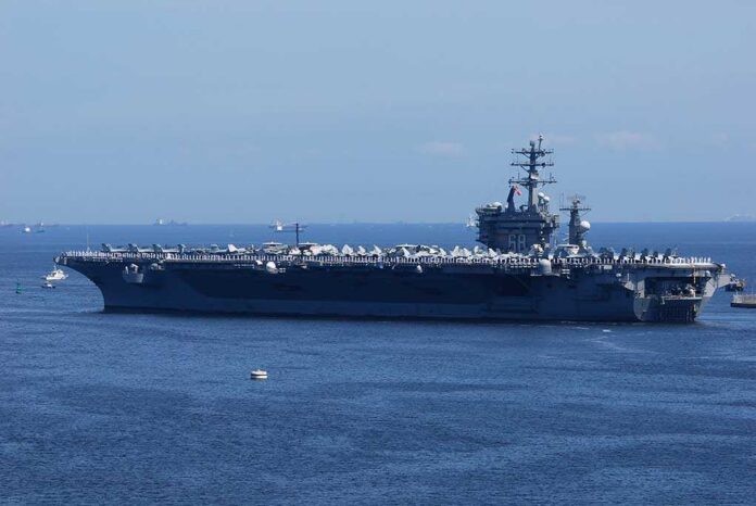 shutterstock_1340097212-1-1-1 A large aircraft carrier sailing in the ocean