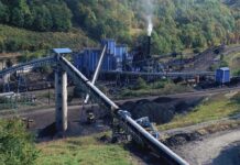 Coal Revival Plan Gains Support Industrial coal processing facility with conveyor belts and smoke stack