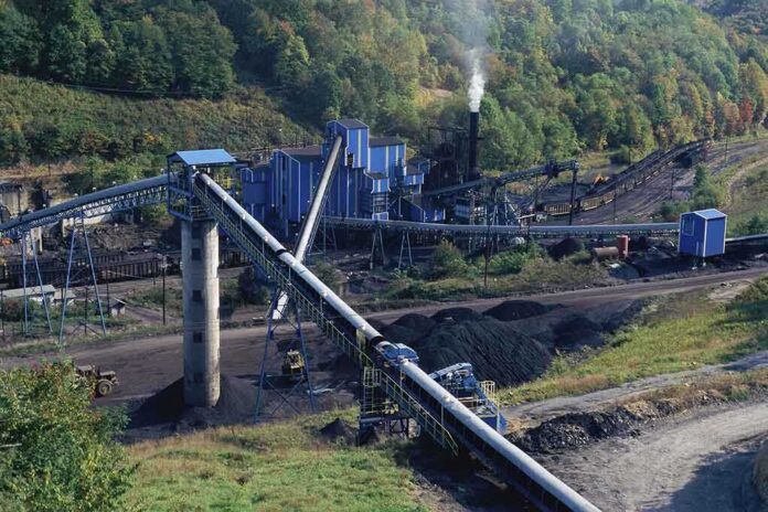 Industrial coal processing facility with conveyor belts and smoke stack