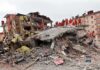 Mass Strike Roars—Civilians Take The Hit Rescue workers in orange uniforms on a collapsed building site after an earthquake