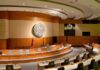 Trump Intelligence Pick Faces Tough Senate Test Interior view of a government chamber with wooden paneling and seating