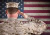 Broken America: Mars Tickets Could Cost Under $100K A soldier in uniform saluting in front of the American flag