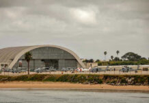 No Flight Logs. No Witnesses. Just a Viral Rumor. Aircraft hangar with helicopters near the beach.