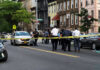Attempted Synagogue Attacker Sent to Therapy Police gathered at an urban crime scene.