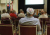 People attending a meeting in a conference room.