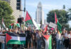 Mayor vs. NBA Star: Foreign Policy Clash Explodes Protesters holding signs and flags in a public square.