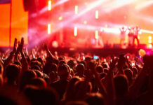 One Viral Fight, One Sold-Out Show Crowd at concert with vibrant stage lights.