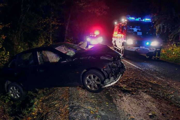 shutterstock_1186155508 Crashed car on a dark roadside with emergency vehicles