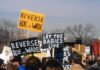 protesters holding anti-abortion signs at a rally