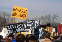 Viewers Blindsided: Ads Air Uncensored protesters holding anti-abortion signs at a rally