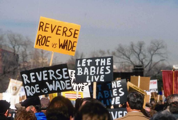 shutterstock_1312893509 protesters holding anti-abortion signs at a rally