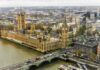 Aerial view of the Houses of Parliament and Big Ben in London, with the Thames River and cityscape